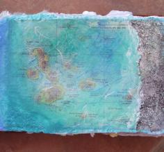 collage and painted map of Galapagos, with sand added for texture