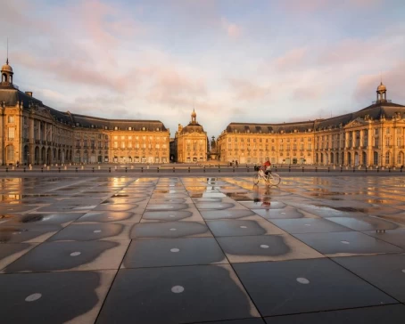 Biking past the Place de la Bourse in Bordeaux
