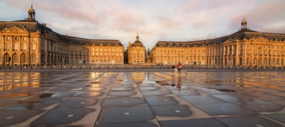 Biking past the Place de la Bourse in Bordeaux