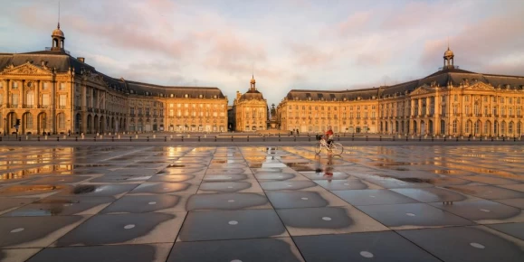 Biking past the Place de la Bourse in Bordeaux