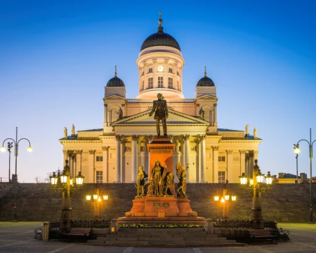 Helsinki Cathedral illuminated at dusk overlooking Senate Square