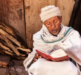 A priest reading from the holy book