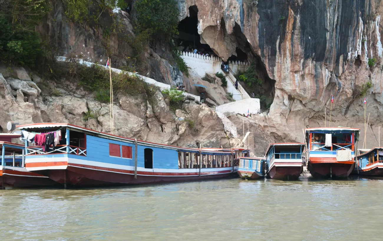 Boats bring travelers to the Pak Ou Cave entrance