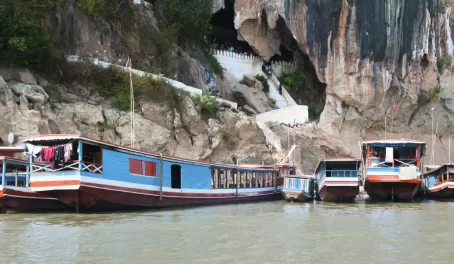 Boats bring travelers to the Pak Ou Cave entrance