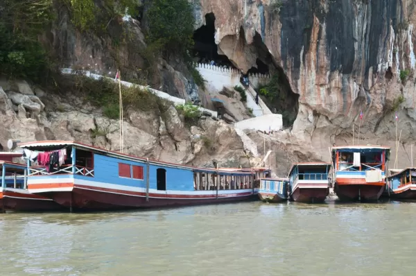 Boats bring travelers to the Pak Ou Cave entrance