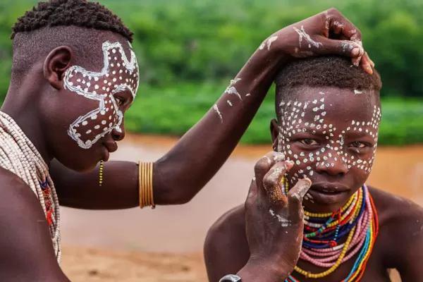 Two young girls painting their faces