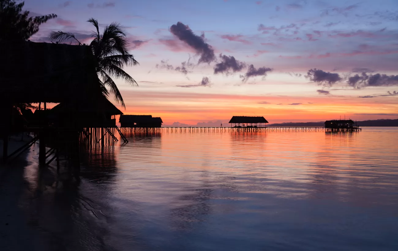 Sunset at an ocean resort in Raja Ampat, West Papua, Indonesia