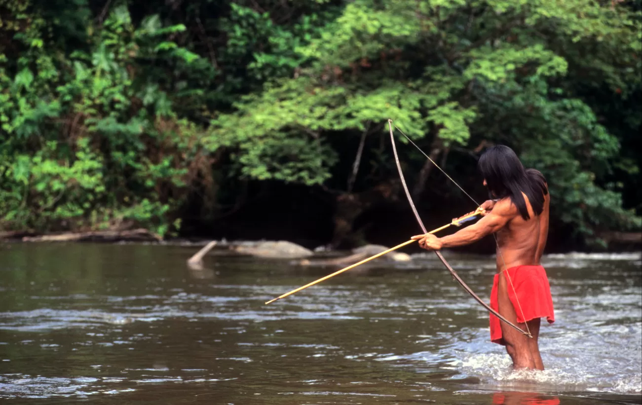 Indigenous man hunting in the Amazon