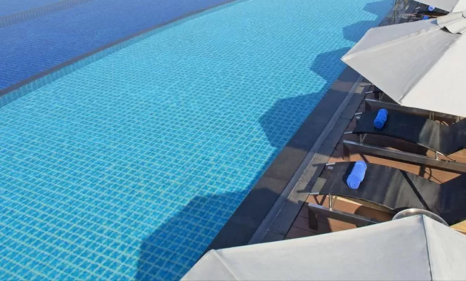 Relax by the swimming pool of the Le Meridien Chiang Rai Resort