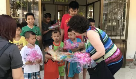Laurie handing out personal gifts to each child at the orphanage.