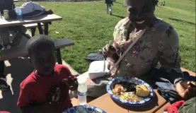 Congolese mother and son enjoy the food and sunshine!