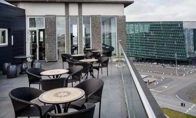 Outdoor patio seating with views of Harpa
