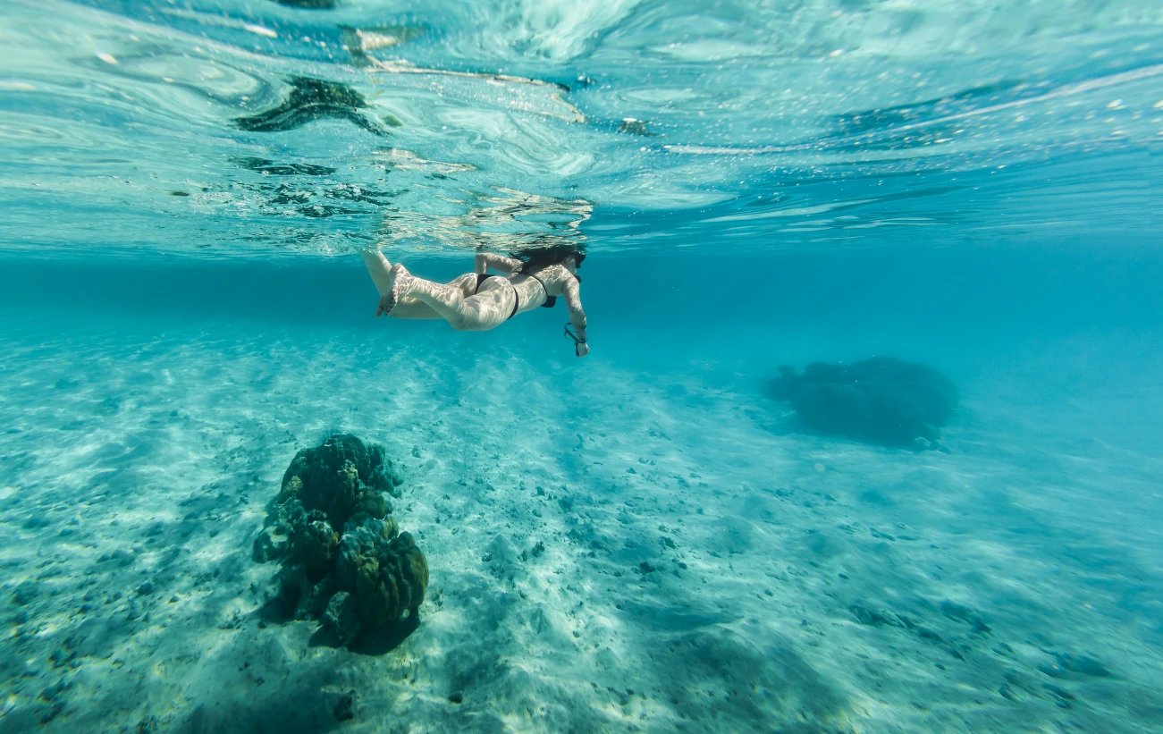 Woman snorkeling in clear water in Bora Bora