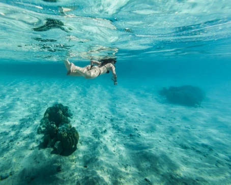 Woman snorkeling in clear water in Bora Bora