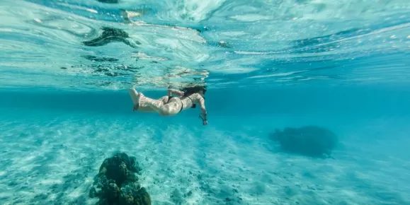 Woman snorkeling in clear water in Bora Bora