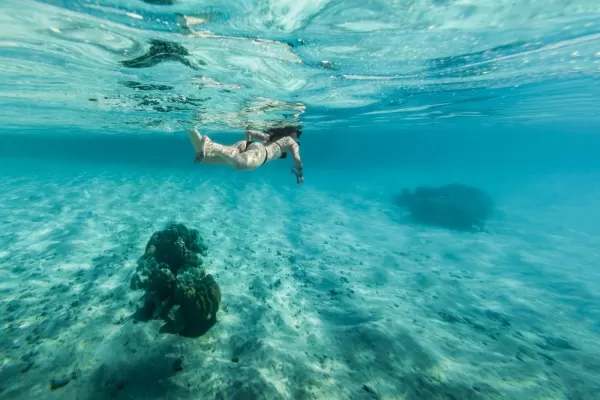 Woman snorkeling in clear water in Bora Bora