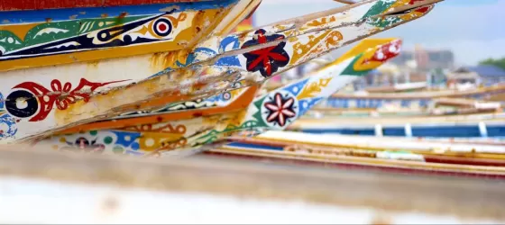 Colorful African pirogue canoes on the beach