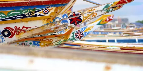 Colorful African pirogue canoes on the beach