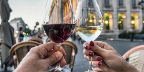 Couple raising glasses with wine