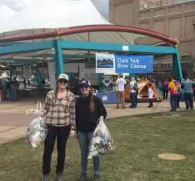 Adlifers Meg and Molly with full bags of collected trash in Caras Park after the cleanup