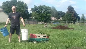 Eric hauls weeds to the compost pile