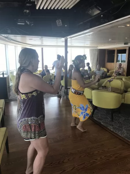 Sister participates in a Polynesian dance lesson