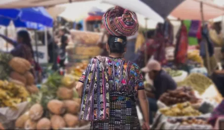A woman balances her goods on her head
