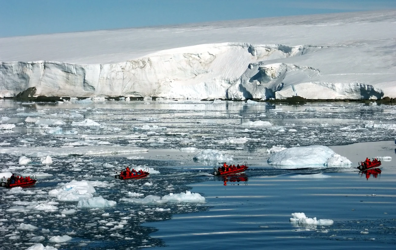 Zodiac cruising among icebergs