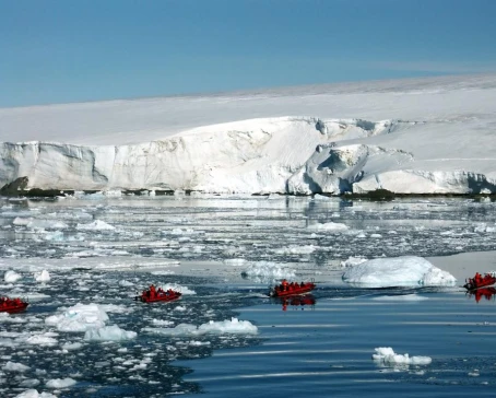 Zodiac cruising among icebergs