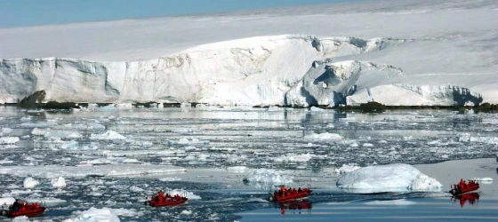 Zodiac cruising among icebergs
