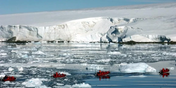 Zodiac cruising among icebergs