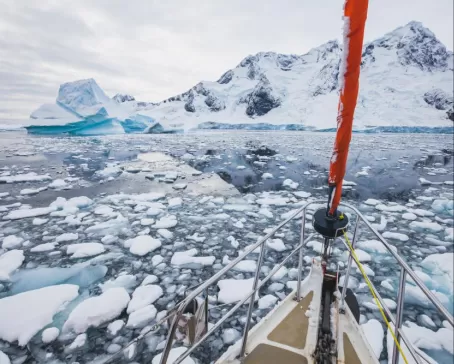 Small iceberg chunks surrounding the prow of the ship