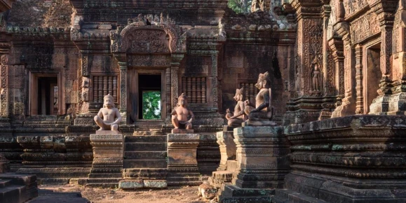 Statues and intricate relief carvings inside Angkor Wat