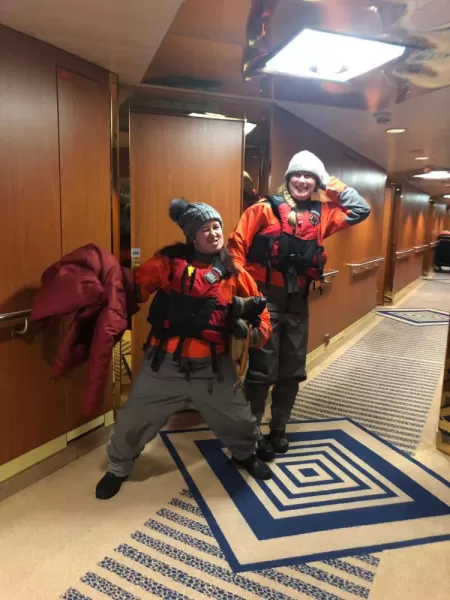 Karen and Meg prepped for kayaking in their dry suits and life jackets
