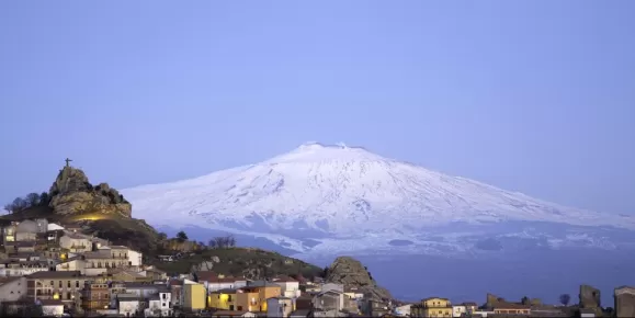 Blue hour over the city in the shadow of Mount Etna