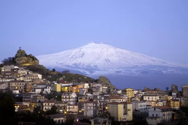 Blue hour over the city in the shadow of Mount Etna