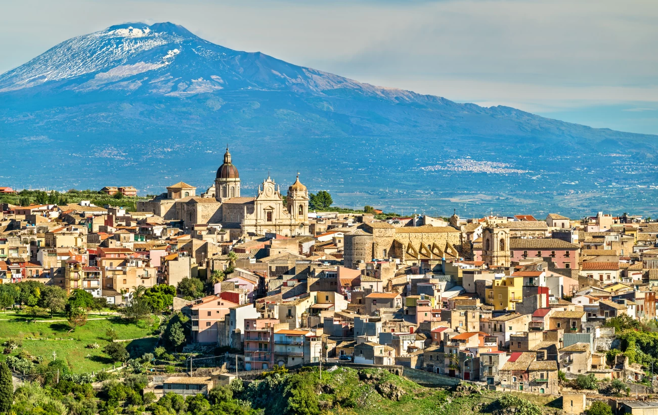 Mount Etna looms over an ancient town