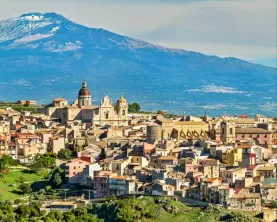 Mount Etna looms over an ancient town