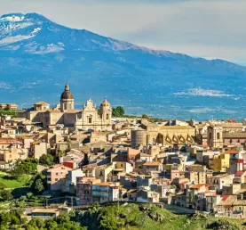 Mount Etna looms over an ancient town