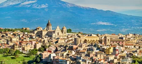 Mount Etna looms over an ancient town