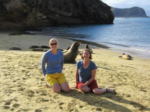 Julia and her mom, Sue, lounging with sea lions in the Galapagos