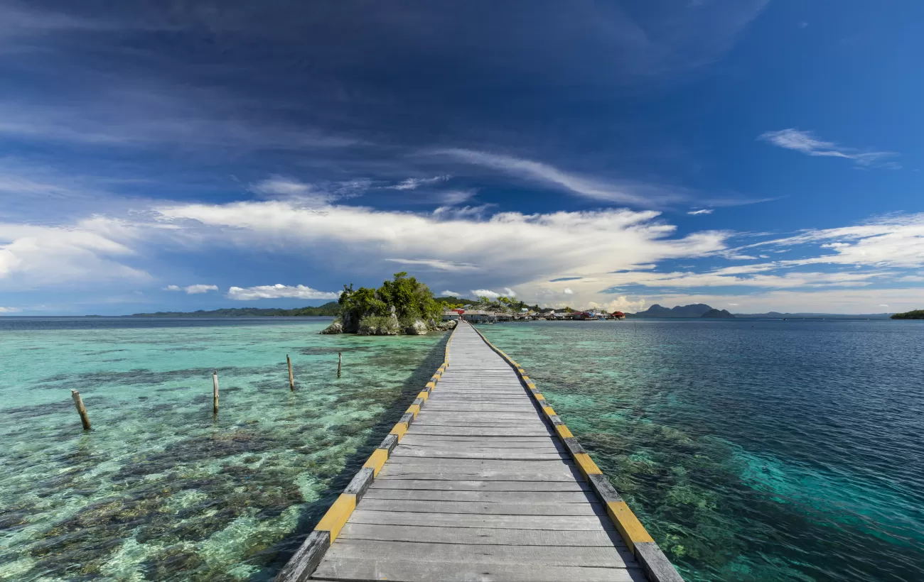 Walk out over the crystal clear waters of Indonesia