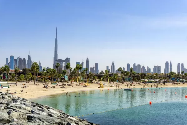 Relax by the beach below the soaring Dubai skyline