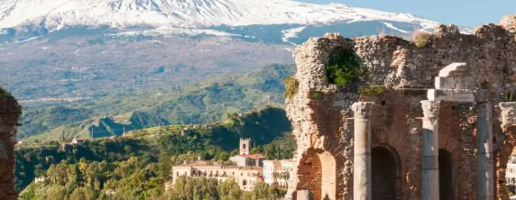 Explore ruins in Taormina within view of volcanic Mount Etna
