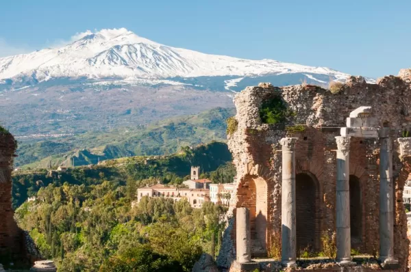 Explore ruins in Taormina within view of volcanic Mount Etna