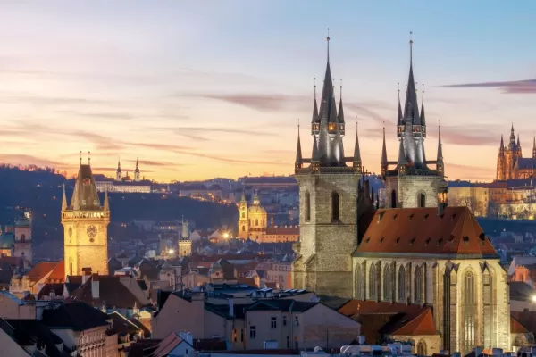 Night falls over the distinctive towers of Prague
