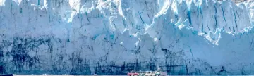A small ship gets close to the glacier for a better look
