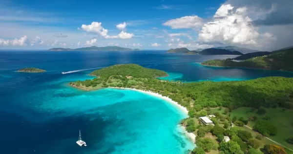 Lush green forests and clear blue waters of the Caribbean