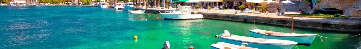 Locals' fishing boats dot the clear green waters