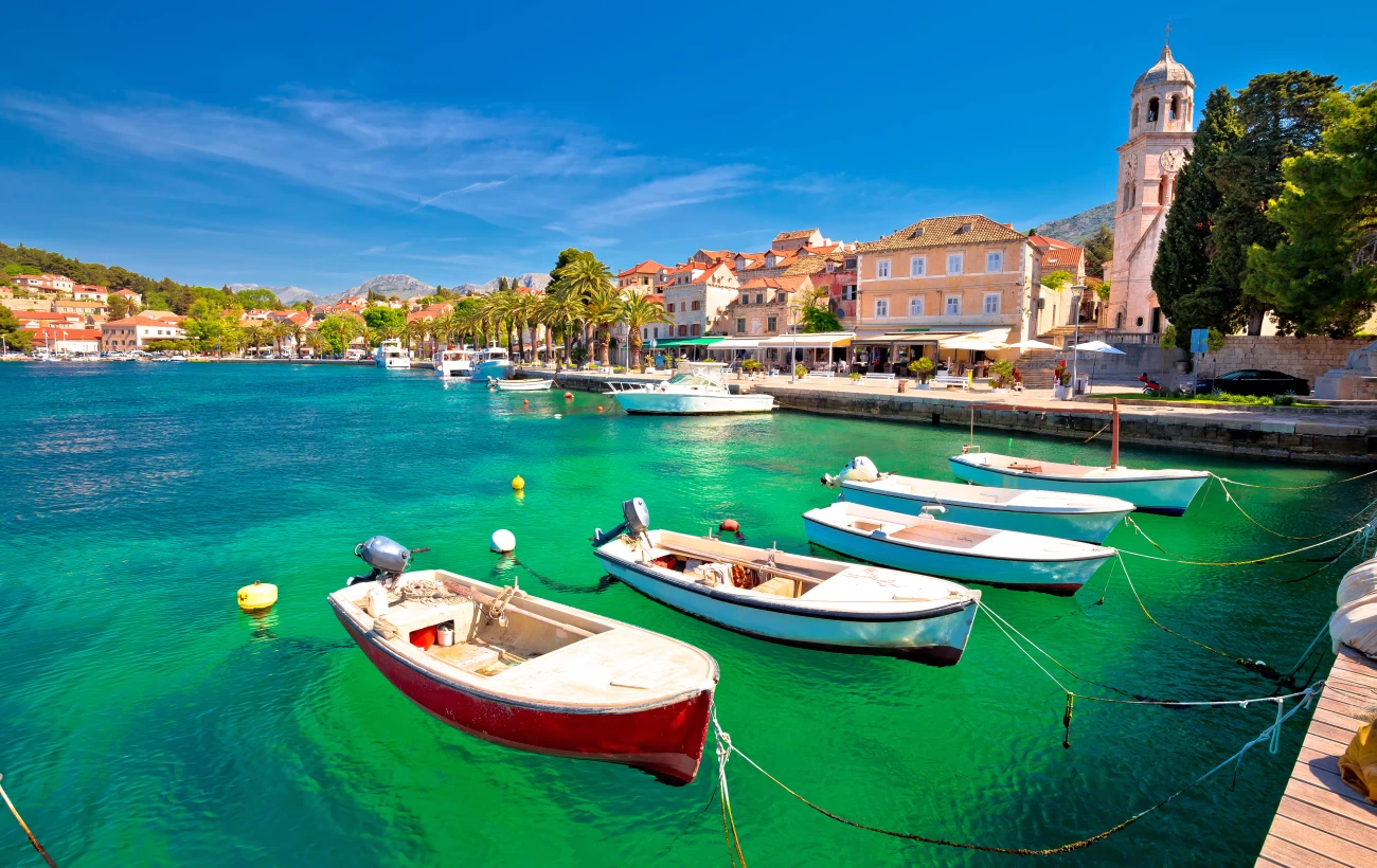 Locals' fishing boats dot the clear green waters